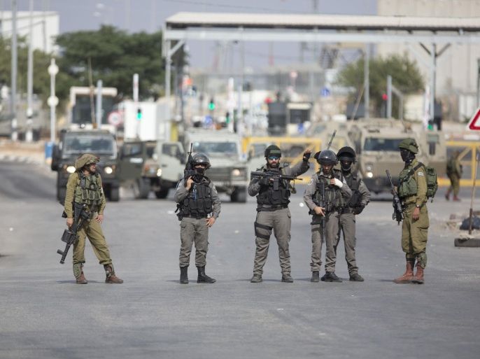 Israeli security forces stand guard as they prevent Palestinians from approaching the area where Palestinian Ahmed Ikmel,16, was killed Saturday after he allegedly attempted to stab an Israeli security guard at the Jalama checkpoint near Jenin, West Bank, Saturday, Oct. 24, 2015. The military said the incident took place at a crossing between Israel and the West Bank. (AP Photo/Majdi Mohammed)