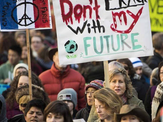 People take part in an internationally organized march called the Global Climate March in Vancouver, British Columbia, Sunday, Nov. 29, 2015. The protest was targeted at sending a message demanding climate action to world leaders meeting at the U.N. climate summit to take place in Paris, France, or COP21. (Jimmy Jeong/The Canadian Press via AP) MANDATORY CREDIT