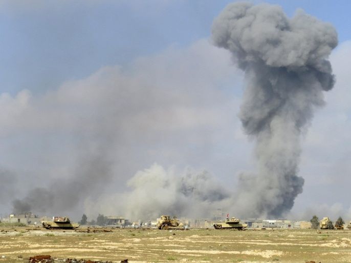 Smoke rises from Islamic State positions following a U.S.-led coalition airstrike while Iraq anti-terrorism forces advance their position during clashes with Islamic State group in the western suburbs of Ramadi, the capital of Iraq's Anbar province, 70 miles (115 kilometers) west of Baghdad, Iraq, Saturday, Nov. 21, 2015. (AP Photo/Osama Sami)