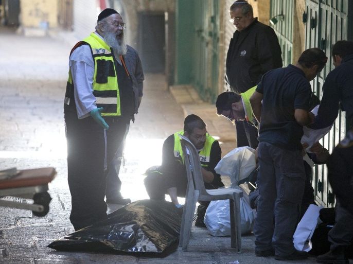 Members of an Israeli ZAKA - Identification, Extraction and Rescue team work at the scene where a Palestinian attacker was killed after he stabbed an Israeli policeman in the alleys of the Old City of Jerusalem, Israel, 29 November 2015. The Palestinian man attacked an Israeli policeman with a knife and was shot dead by another Israeli policeman, a spokesman for the Israeli police said.