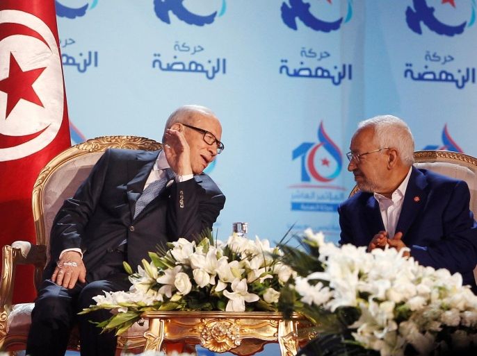Tunisian President Beji Caid Essebsi (L), talks with Rached Ghannouchi, leader of the Islamist Ennahda movement, during the congress of the Ennahda Movement in Tunis, Tunisia May 20, 2016. REUTERS/ Zoubeir Souissi