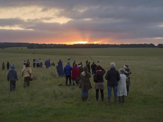 Revellers celebrate the summer solstice at Stonehenge on Salisbury Plain in southern England, Britain June 21, 2015. Stonehenge is a celebrated venue of festivities during the summer solstice - the longest day of the year in the northern hemisphere - and it attracts thousands of revellers, spiritualists and tourists. Druids, a pagan religious order dating back to Celtic Britain, believe Stonehenge was a centre of spiritualism more than 2,000 years ago. REUTERS/Kieran Doherty