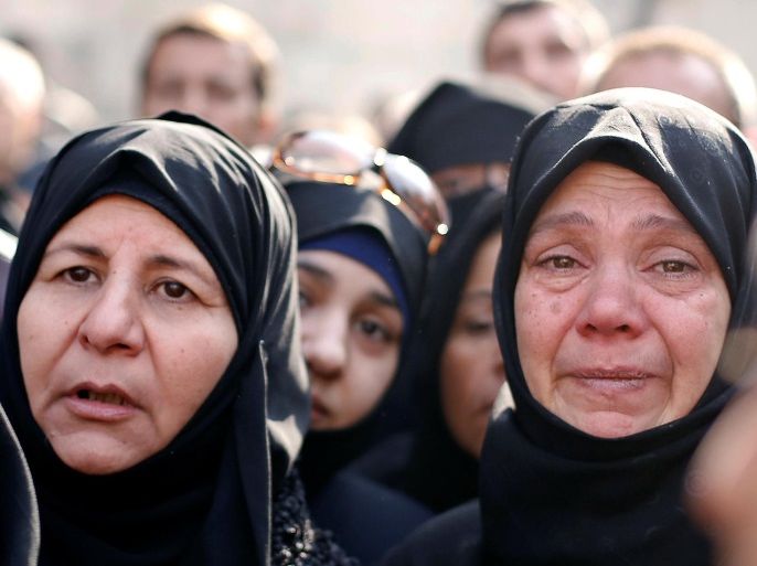 Women react as they wait outside a government military police centre to visit their relatives, who were evacuated from the eastern districts of Aleppo and are being prepared to begin their military service, in Aleppo, Syria December 11, 2016. REUTERS/Omar Sanadiki
