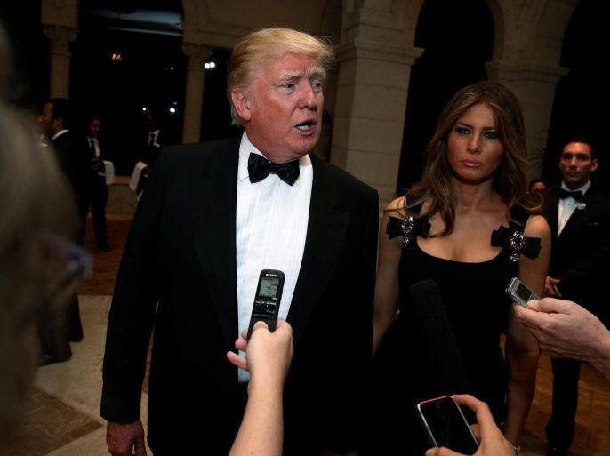 U.S. President-elect Donald Trump talks to reporters as he and his wife Melania Trump arrive for a New Year's Eve celebration with members and guests at the Mar-a-lago Club in Palm Beach, Florida, U.S. December 31, 2016. REUTERS/Jonathan Ernst