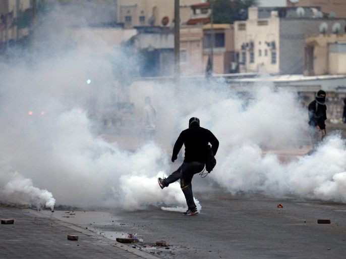 A protester kicks tear gas canister away, fired by riot police during a demonstration to mark the 6th anniversary of the February 14 uprising, in the village of Sitra, south of Manama, Bahrain February 14, 2017. REUTERS/Hamad I Mohammed