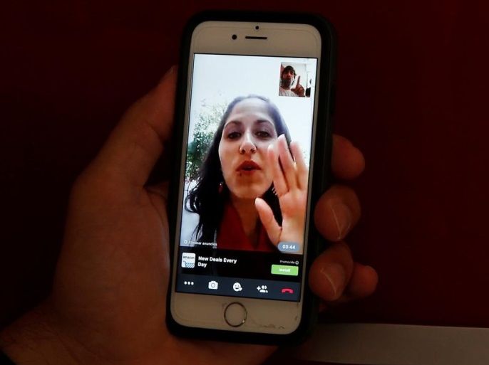 Sergio Colas communicates with his wife Alma via FaceTime so that they can read each others lips during the San Fermin festival in Pamplona, northern Spain, July 7, 2016. REUTERS/Susana Vera SEARCH "SERGIO COLAS" FOR THIS STORY. SEARCH "THE WIDER IMAGE" FOR ALL STORIES.