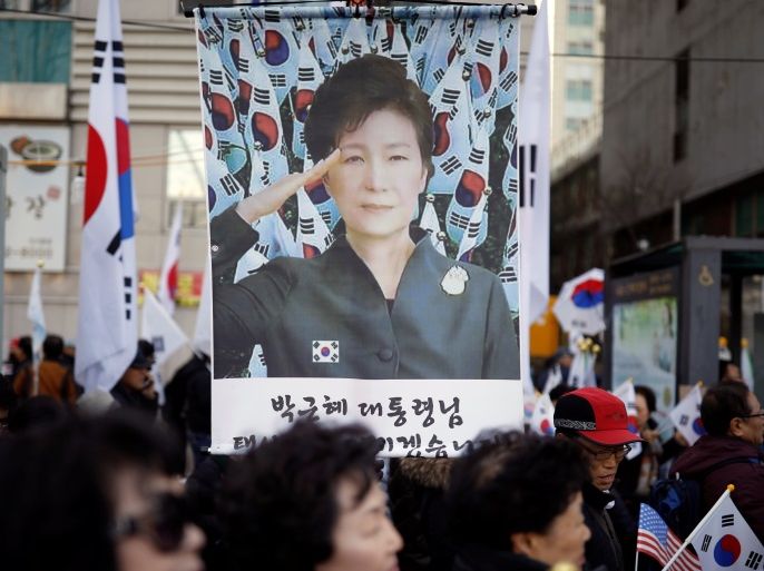 Supporters of South Korean President Park Geun-hye holding national flag Taegeukgi attend a protest called