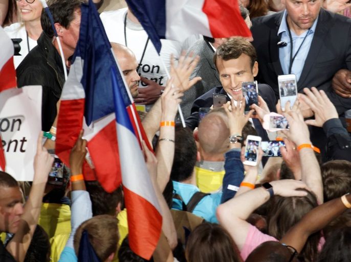 PARIS, FRANCE - APRIL 17: French presidential candidate Emmanuel Macron waves as he arrives to delivers a speech during a campaign rally at Bercy Arena on April 17, 2017 in Paris, France. (Photo by Sylvain Lefevre/Getty Images)