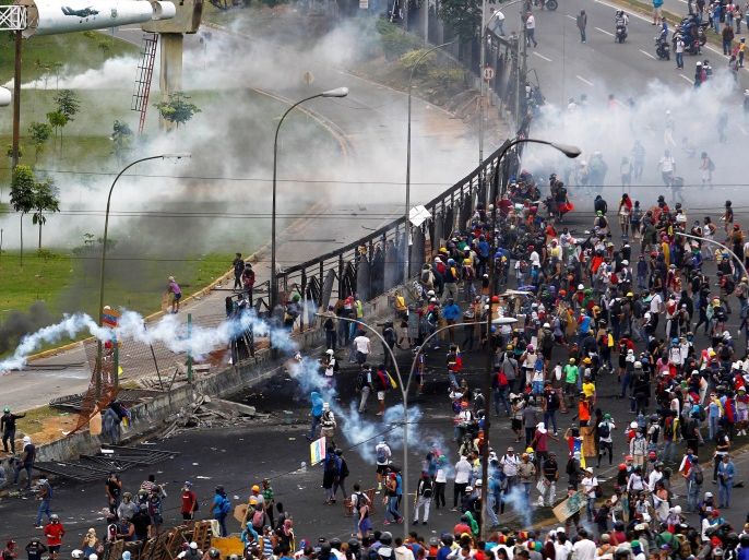 Demonstrators protest in the perimeter of an Air Force base during a rally against Venezuela's President Nicolas Maduro's Government in Caracas, Venezuela, June 24, 2017. REUTERS/Christian Veron TPX IMAGES OF THE DAY