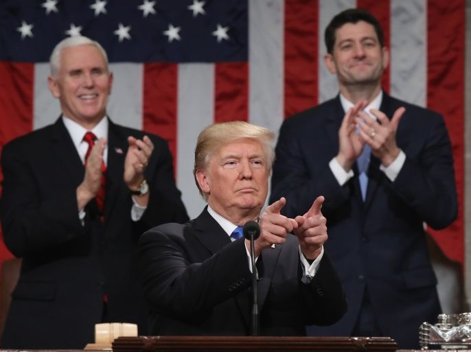 U.S. President Donald J. Trump (C) gestures at the podium in front of U.S. Vice President Mike Pence (L) and Speaker of the House U.S. Rep. Paul Ryan (R-WI) during his first State of the Union address to a joint session of Congress inside the House Chamber on Capitol Hill in Washington, U.S., January 30, 2018. REUTERS/Win McNamee/Pool