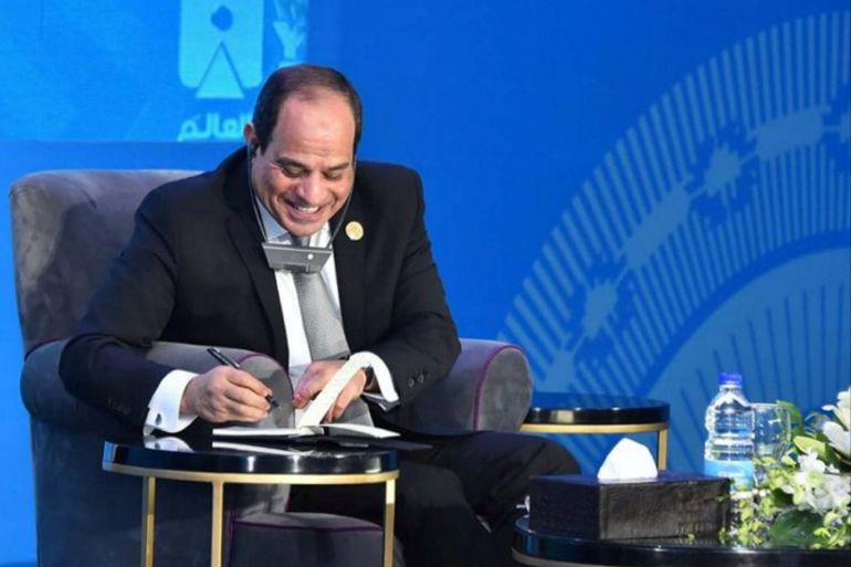 Egyptian President Abdel Fattah al-Sisi smiles and writes his comments during a panel discussion at the 2nd World Youth Forum (WYF) in Sharm el-Sheikh, Egypt, November 5, 2018 in this handout picture courtesy of the Egyptian Presidency. The Egyptian Presidency/Handout via REUTERS ATTENTION EDITORS - THIS IMAGE WAS PROVIDED BY A THIRD PARTY