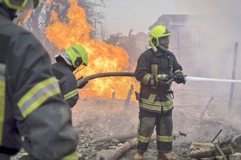EDITORS NOTE: Graphic content / This handout photograph taken and released by Ukrainian Emergency Service on March 15, 2024 shows rescuers extinguishing a fire at the site of a missile attack in Odesa. - Ukrainian authorities said on March 15, 2024 that the death toll from a Russian strike on the Black Sea port city of Odesa had grown to 14 with dozens more injured. (Photo by Handout / UKRAINIAN EMERGENCY SERVICE / AFP) / RESTRICTED TO EDITORIAL USE - MANDATORY CREDIT "AFP PHOTO / UKRAINIAN EMERGENCY SERVICE" - NO MARKETING NO ADVERTISING CAMPAIGNS - DISTRIBUTED AS A SERVICE TO CLIENTS - RESTRICTED TO EDITORIAL USE - MANDATORY CREDIT "AFP PHOTO / UKRAINIAN EMERGENCY SERVICE" - NO MARKETING NO ADVERTISING CAMPAIGNS - DISTRIBUTED AS A SERVICE TO CLIENTS /