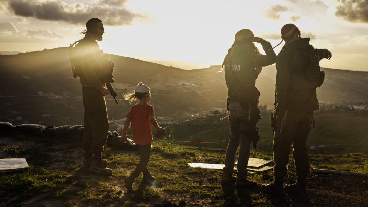 YITZHAR, OCCUPIED WEST BANK -- FEBRUARY 6, 2024: Tuvia levy 26, from left, Yosef, 5, Yishai Sheinman, 27 and Marom Harel, 25, look on at nearby Palestinian towns from their security outpost in Yitzhar, Occupied West Bank , Tuesday, Feb. 6, 2024. 27-year-old Yishai Sheinman, has been at work establishing illegal outposts of a nearby hilltop settlement, known as Yitzhar. For a long time, Israeli soldiers were tasked with stopping the expansion of settlements, which much of the world, including the United States, view as a illegal under international law. Soldiers sometimes clashed with Yishai, who belongs to an extremist group called the Hilltop Youth, with security forces regularly tearing down homes that the Hilltop Youth tried to construct on land claimed by Palestinians, and intervening when their attempts at antagonizing their Palestinian neighbors turned violent. (MARCUS YAM / LOS ANGELES TIMES)