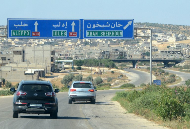 Signs show the directions to Syrian cities at the entrance of Khan Sheikhun in the northern Idlib province on August 24, 2019, a day after regime forces announced the total control of the city. Regime forces massed today in northwest Syria, a monitor said, in an apparent bid to press an offensive against jihadists and allied rebels that has heightened tensions with neighbouring Turkey. (Photo by Maher AL MOUNES / AFP)