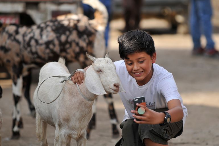 A boy takes selfie with the goast after buying for the Bakra Eid or Eid al-Adha or Id-ul-Azha on Sunday, August 11, 2019 in Kathmandu, Nepal. Bakra Eid, also known Eid al-Adha or Id-ul-Azha in Arabic, is a 'Feast of Sacrifice' and celebrated as the time to give and to sacrifice. Nepalese goverment announced a public holiday on the occasion of Bakra Eid or Eid al-Adha or Id-ul-Azha, one of the two major festivals for Muslims worldwide. (Photo by Narayan Maharjan/NurPhoto via Getty Images)
