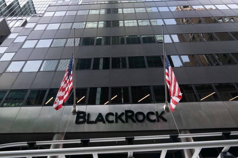 Flags fly on the front of BlackRock headquarters, Wednesday, Jan. 13, 2021, in New York. The financial asset manager reports earnings Thursday, Jan. 14. (AP Photo/Mark Lennihan)