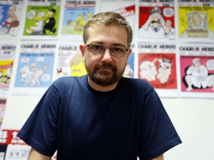 French satirical weekly Charlie Hebdo's publisher, known only as Charb, presents his new comic strip named 'La Vie de Mahomet' (The life of Mohammed) in Paris on December 27, 2012.