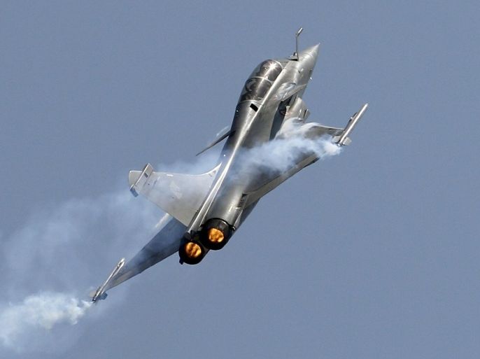 Rafale, a French fighter aircraft flies over static display area on the final day of Aero India air show at Yelahanka air base in Bangalore, India, Sunday, Feb. 22, 2015. Aero India is a biennial event with flying demonstrations by stunt teams and militaries and commercial pavilions where aviation companies display their products and technology. (AP Photo/Aijaz Rahi)