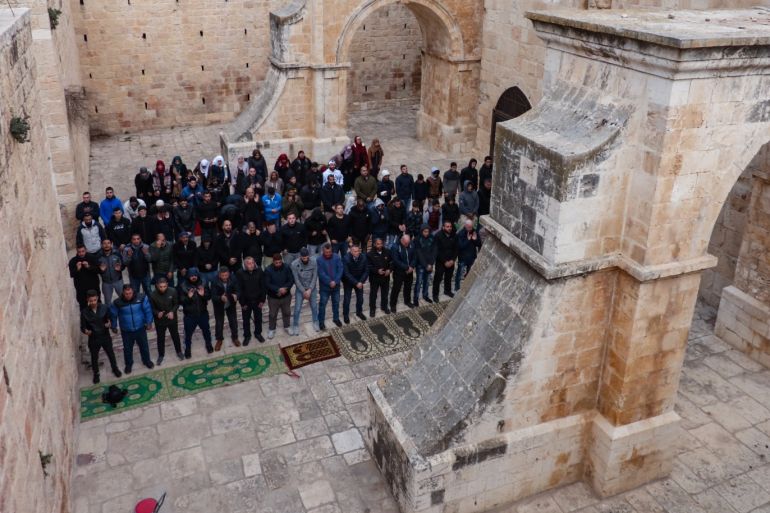 Israeli police chains Gate of Mercy in Jerusalem- - JERUSALEM - FEBRUARY 21: Palestinians perform morning, noon and afternoon prayers in front of Al-Rahma Gate (Gate of Mercy) of Al-Aqsa Mosque Compound, after it was chained by Israeli police in Jerusalem on February 21, 2019.