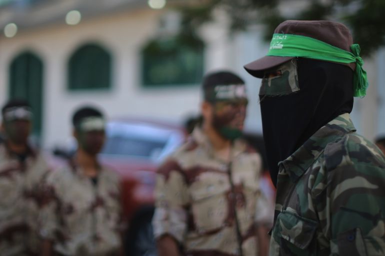 KHAN YUNIS, GAZA - JUNE 15: Young cadets from the Izzedine al-Qassam Brigades, a military wing of Hamas, provide a guard of honour for school students taking part in a graduation ceremony in the town square of Khan Yunis on June 15, 2015, Khan Yunis, Gaza. The devastation across Gaza can still be seen nearly one year on from the 2014 conflict between Israel and Palestinian militants. Money pledged by the international community six months ago to rebuild Gaza has not materialised leaving many Palestinians impoverished and still suffering with the poor economy. United Nations official figures said that the 50 day war left at least 2,189 Palestinians dead, including more than 1,486 civilians, and 11,000 injured. 67 Israeli soldiers and six civilians were killed. (Photo by Christopher Furlong/Getty Images)