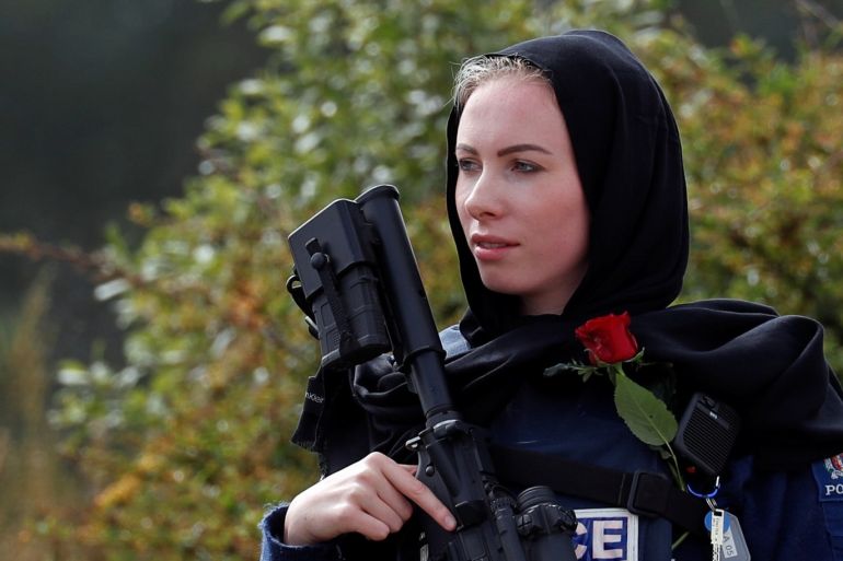 A policewoman is seen as people attend the burial ceremony of a victim of the mosque attacks, at the Memorial Park Cemetery in Christchurch, New Zealand March 21, 2019. REUTERS/Jorge Silva