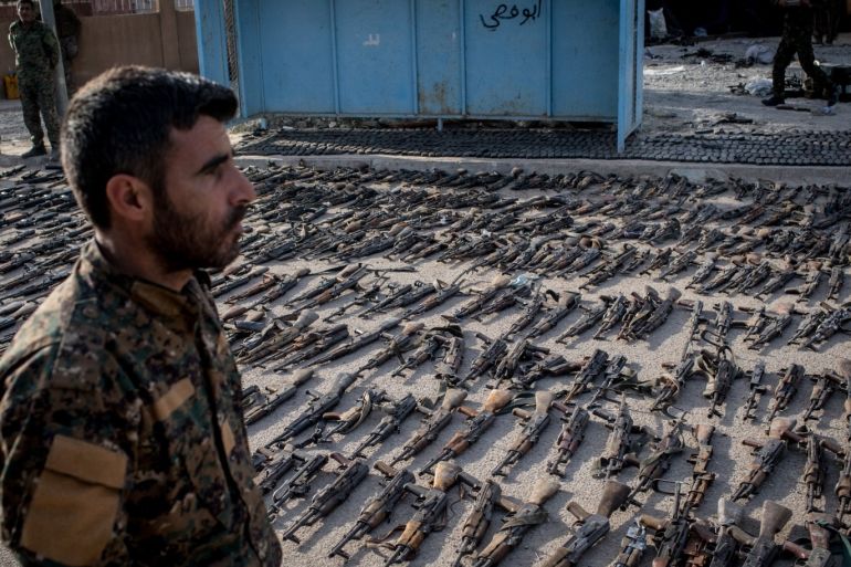 AL MAYADIN, SYRIA - MARCH 22: An SDF (Syrian Democratic Forces) fighter looks over seized ISIL weapons that were found in the last stronghold of the extremist group as they were displayed at an SDF base on March 22, 2019 outside Al Mayadin, Syria. In recent days the U.S.-backed Syrian Democratic Forces have taken control of the ISIL encampment on the eastern bank of the Euphrates in Baghouz, the extremist groups last hold out. The SDF have combed the area in an attempt