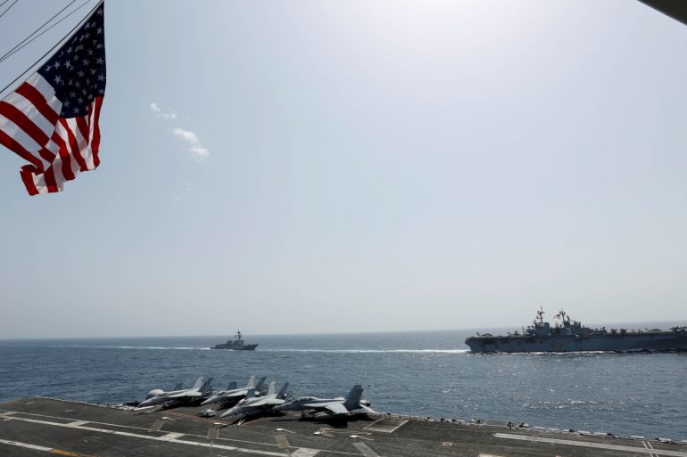 The U.S. Navy Wasp-class amphibious assault ship USS Kearsarge and the Arleigh Burke-class guided-missile destroyer USS Bainbridge sail alongside the Nimitz-class aircraft carrier USS Abraham Lincoln in the Arabian Sea May 17, 2019. Picture taken May 17, 2019. US Navy/Mass Communication Specialist Seaman Michael Singley/Handout via REUTERS. ATTENTION EDITORS - THIS IMAGE WAS PROVIDED BY A THIRD PARTY.