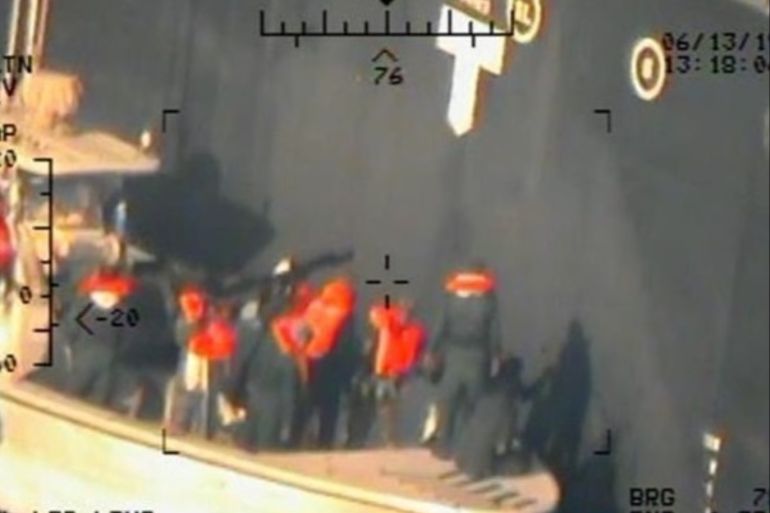 A U.S. military image released by the Pentagon in Washington on June 17, which is says was taken from a U.S. Navy MH-60R helicopter in the Gulf of Oman in waters between Gulf Arab states and Iran on June 13, shows personnel that the Pentagon says are members of the Islamic Revolutionary Guard Corps Navy removing an unexploded limpet mine from the M/T Kokuka Courageous, a Japanese owned commercial motor tanker. Picture taken June 13, 2019. U.S. Navy/Handout via REUTERS ATTENTION EDITORS-THIS IMAGE HAS BEEN SUPPLIED BY A THIRD PARTY.