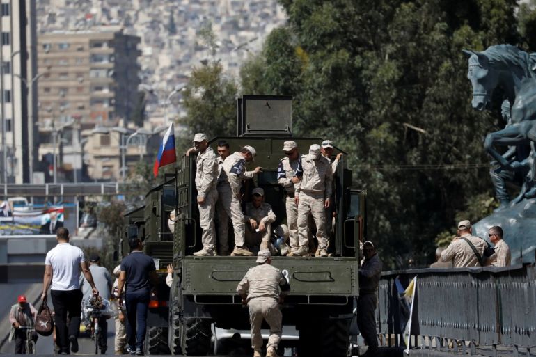 Russian soldiers stand on a truck in central Damascus, Syria, September 14, 2018. Picture taken September 14, 2018. REUTERS/Marko Djurica