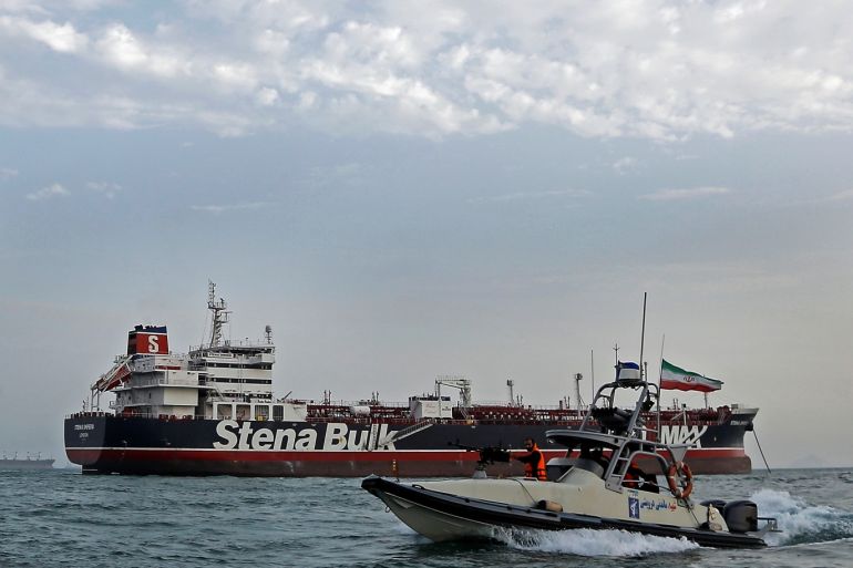 A boat of Iranian Revolutionary Guard sails next to Stena Impero, a British-flagged vessel owned by Stena Bulk, at Bandar Abbas port, July 21, 2019. Iran, Mizan News Agency/WANA Handout via REUTERS ATTENTION EDITORS - THIS IMAGE WAS PROVIDED BY A THIRD