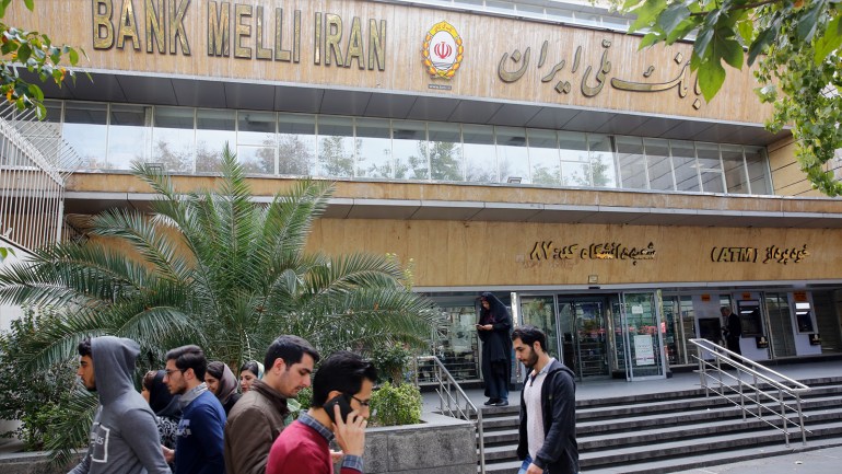 epa07138454 Iranians walk in front of a branch of the Bank Melli Iran in Tehran, Iran, 03 November 2018. US President Donald J. Trump's administration announced on 02 November 2018, that it will reimpose sanctions against Iran that had been waived under the 2015 Iran nuclear deal (the Joint Comprehensive Plan of Action, JCPOA). The US sanctions will take effect on 05 November 2018, covering Iran's shipping, financial and energy sectors. In 2015, five nations, including the United States, worked out a deal with the Middle Eastern country that withdrew the sanctions, one of former US President Barack Obama's biggest diplomatic achievements. EPA-EFE/ABEDIN TAHERKENAREH