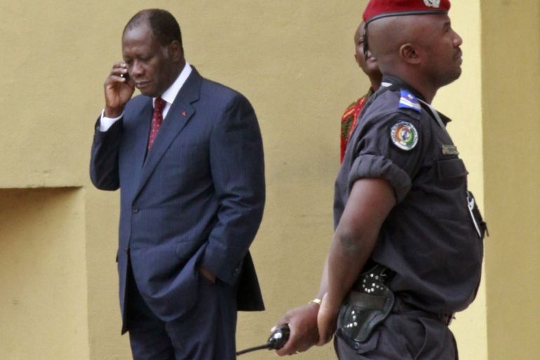 Alassane Ouattara (L) speaks on his mobile phone at the Golf Hotel, his headquarters in Abidjan December 27, 2010. An election meant to resolve Ivory Coast's decade-long political crisis has resulted in two rivals claiming the presidency, with incumbent Laurent Gbagbo defying world pressure to hand over to Ouattara. The standoff has killed more than 170 people, according to the United Nations, and threatens to push the West African country back into civil war. REUTERS/Thierry Gouegnon (IVORY COAST - Tags: POLITICS CIVIL UNREST MILITARY)