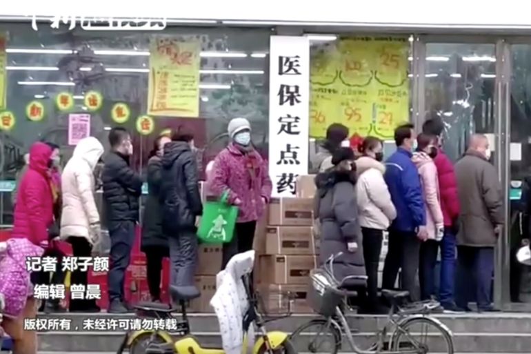 People wearing masks queue at a shop in Wuhan, Hubei province, China January 23, 2020, in this still image taken from video. China News Service/via REUTERS TV. CHINA OUT. NO COMMERCIAL OR EDITORIAL SALES IN CHINA
