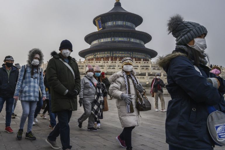 BEIJING, CHINA - JANUARY 27: Visitors wear protective masks as they tour the grounds of the Temple of Heaven, which remained open during the Chinese New Year and Spring Festival holiday on January 27, 2020 in Beijing, China. The number of cases of a deadly new coronavirus rose to over 2700 in mainland China Sunday as health officials locked down the city of Wuhan last week in an effort to contain the spread of the pneumonia-like disease which medicals experts have confirmed can be passed from human to human. In an unprecedented move, Chinese authorities put travel restrictions on the city which is the epicentre of the virus and neighbouring municipalities affecting tens of millions of people. The number of those who have died from the virus in China climbed to at least 80 on Monday and cases have been reported in other countries including the United States, Canada, Australia, France, Thailand, Japan, Taiwan and South Korea. Due to concerns over the spread of the virus, the Beijing government closed many popular attractions such as the Forbidden City and sections of the Great Wall among others. (Photo by Kevin Frayer/Getty Images)