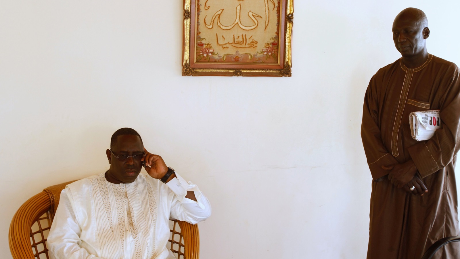 ‪الرئيس السنغالي ماكي سال يجري مكالمة هاتفية داخل منزله في العاصمة داكار‬ (رويترز)