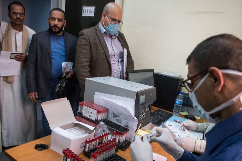 epa08298777 Egyptians wait to take Covid-19 test at the Central Public Health Laboratories in Cairo, Egypt, 16 March 2020. The number of cases infected with SARS-CoV-2 Coronavirus causing the Covid-19 disease in Egypt increased to 126.  EPA-EFE/MOHAMED HOSSAM