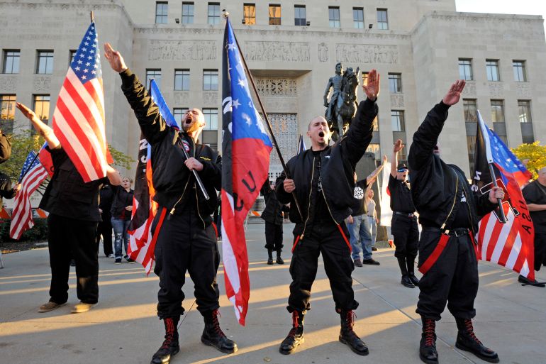 Members of the National Socialist Movement "salute" a speaker during a neo-Nazi rally at the Jackson County Courthouse November 9, 2013 in Kansas City, Missouri. The date is the 75th anniversary of Kristallancht, when Nazi Storm Troopers and others killed almost an estimated 91 Jews, destroyed synagogues, Jewish homes and shops and began the process that became the HolocaustREUTERS/Dave Kaup (UNITED STATES - Tags: CIVIL UNREST POLITICS)