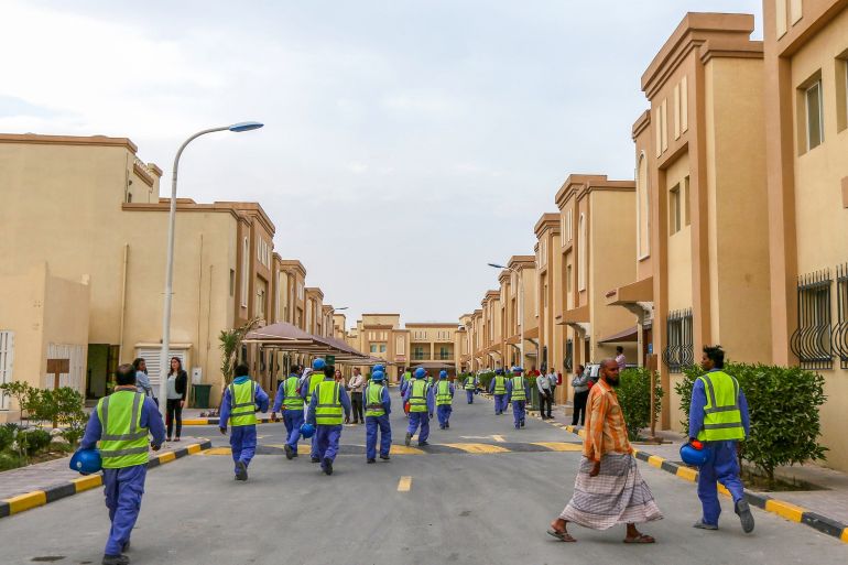 Foreign laborers working on the construction site of the al-Wakrah football stadium, one of the Qatar's 2022 World Cup stadiums, walk back to their accomodation at the Ezdan 40 compound after finishing work on May 4, 2015, in Doha's Al-Wakrah southern suburbs. The Qatari government has announced new projects to provide better accommodation for up to one million migrant workers. Today they organised a media tour of existing housing camps and new ones. AFP PHOTO / MARWA