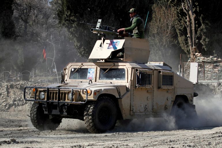 FILE PHOTO: An armoured vehicle patrols near the side of an incident where two U.S soldiers were killed a day before in Shirzad district of Nangarhar province, Afghanistan February 9, 2020.REUTERS/Parwiz/File Photo