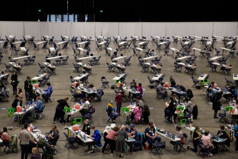 People receive their coronavirus disease (COVID-19) vaccines at a mass vaccination site at Lumen Field Event Center in Seattle