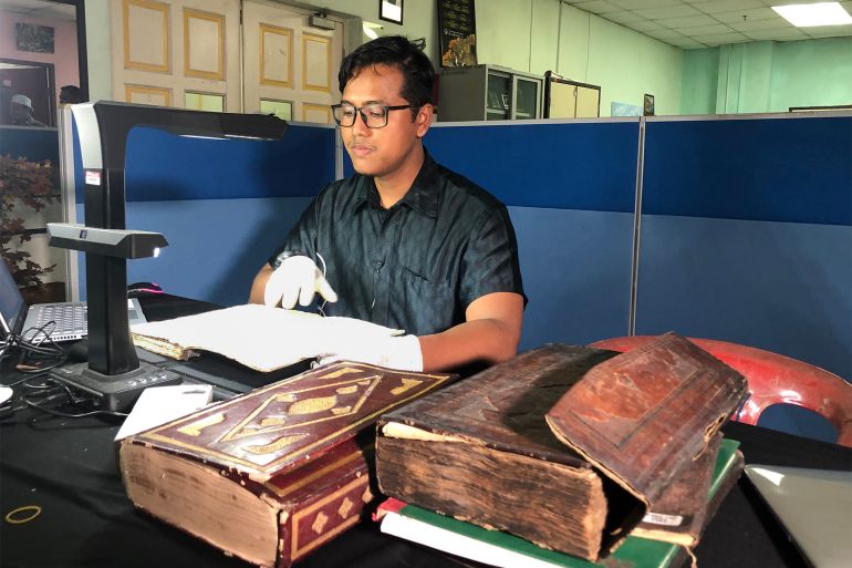 باحث يعمل على ترميم المخطوطات في متحف ترينغانو بماليزيا