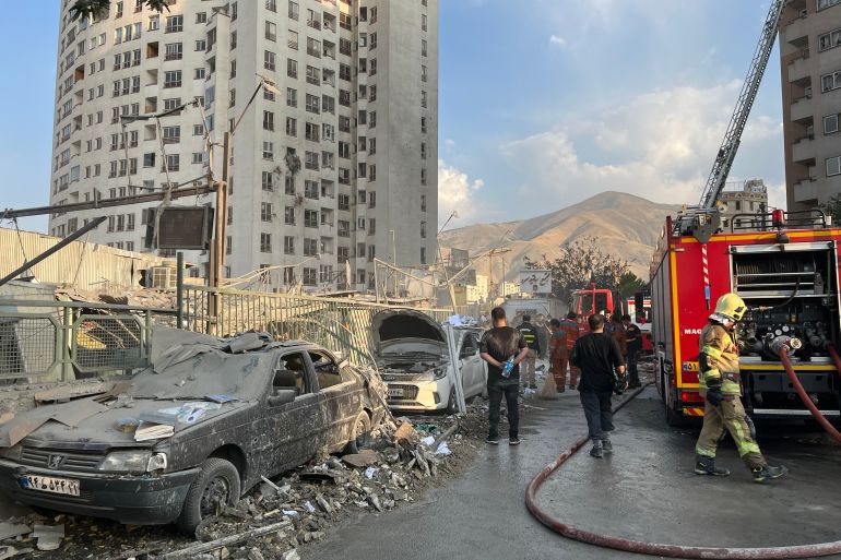 epa12172720 Fire fighters work outside a building that was hit by Israeli air strikes north of Tehran, Iran, 13 June 2025. Israel confirms it has launched strikes on Iran's 'nuclear program' as blasts are heard across the country. The strikes are part of Operation Rising Lion, Israel's Prime Minister Benjamin Netanyahu said, adding Iran was a threat to "Israel's very survival". EPA-EFE/ABEDIN TAHERKENAREH