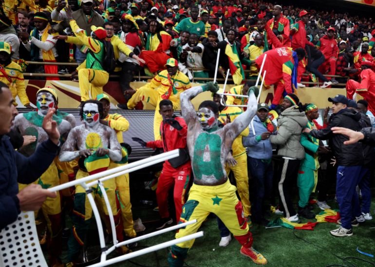 Soccer Football - CAF Africa Cup of Nations - Morocco 2025 - Final - Senegal v Morocco - Prince Moulay Abdellah Stadium, Rabat, Morocco - January 18, 2026 Senegal fans clash with security as fans invade the pitch after Morocco were awarded a penalty following a VAR review REUTERS/Siphiwe Sibeko