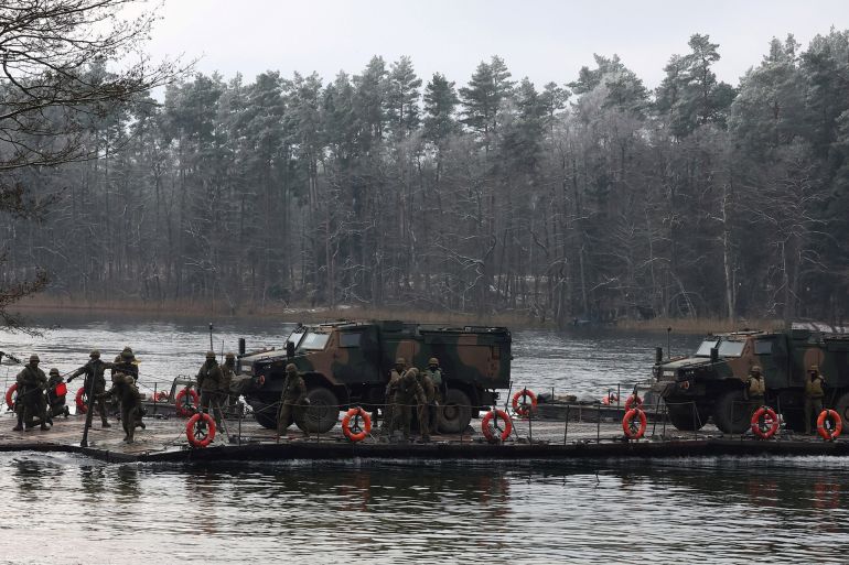 Polish military vehicles are transported during TUMAK-22 NATO exercises in an area known as the Suwalki Gap, of crucial significance to the security of the alliance's eastern flank, at a polygon in Klusy, Poland November 25, 2022. REUTERS/Kacper Pempel