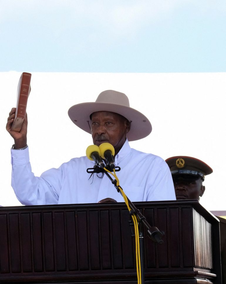Uganda's President and leader of the ruling National Resistance Movement (NRM) party, Yoweri Museveni, holds up the Bible as he is sworn in after being declared the winner of the country's presidential election, extending his decades-long rule, at the Kololo grounds in Kampala, Uganda May 12, 2026. REUTERS/Abubaker Lubowa
