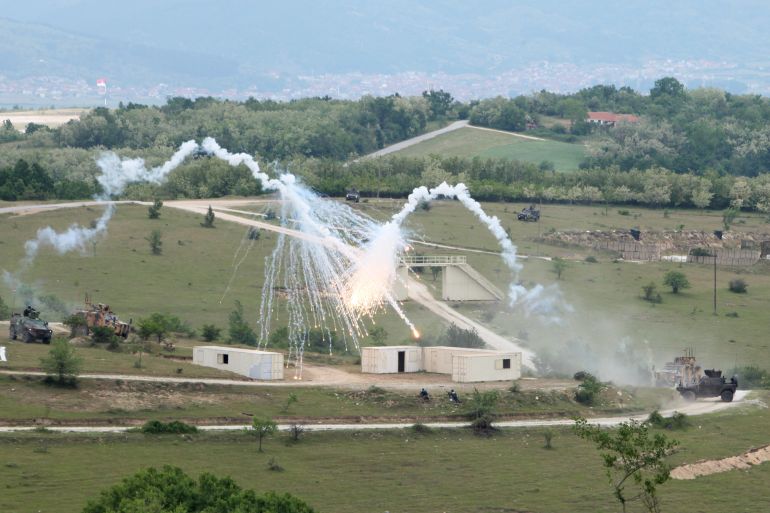 Serbian Army soldiers and soldiers from NATO countries perform during a first Serbia-NATO joint military exercise at training ground near the village of Borovac, south Serbia, Friday, May 22, 2026. (AP Photo/Jelena Djukic-Pejic)