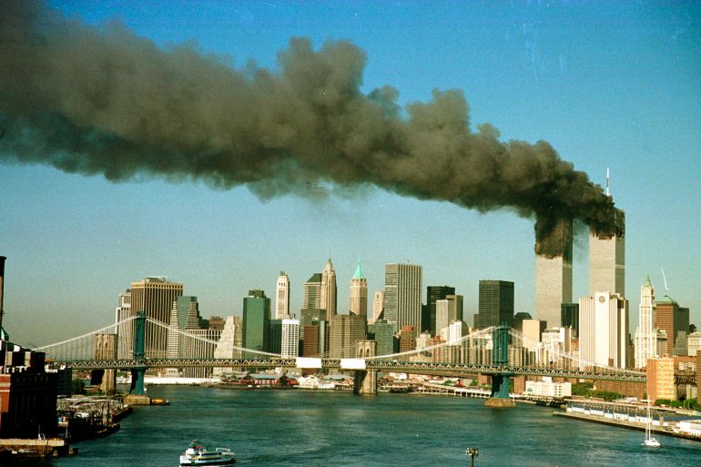 A September 11, 2001 file photo shows the towers of New York's World Trade Center pour smoke shortly after being struck by hijacked commercial aircraft. New York City plans to mark the third anniversary of the attacks on the trade center with an observance at the site on September 11 with parents and grandparents of victims reading their names. REUTERS/Brad Rickerby JDP