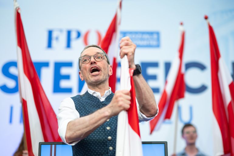 LINZ, AUSTRIA - MAY 01: Herbert Kickl, leader of the far-right Freedom Party of Austria (FPOe), with an Austrian flag at an FPOe May Day gathering on May 01, 2025 in Linz, Austria. The FPOe won parliamentary elections last year but failed to find a coalition partner to create a government. The party does rule in coalitions in five Austrian state governments. (Photo by Christian Bruna/Getty Images)