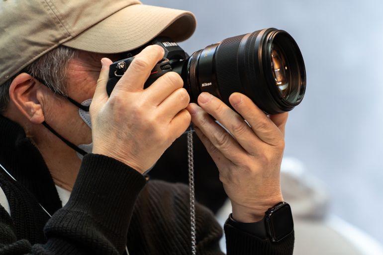 YOKOHAMA, JAPAN - FEBRUARY 27: An attendee tries out a mirrorless digital camera in the Nikon booth during the CP+ (CP Plus) 2025 show on February 27, 2025, in Yokohama, Japan. One of the world's largest trade shows for camera, lens and imaging products is held through March 2. (Photo by Tomohiro Ohsumi/Getty Images)