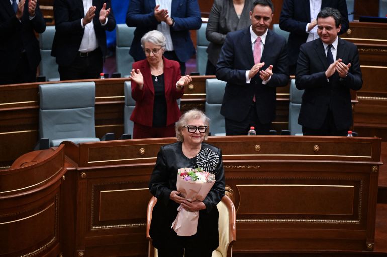 Newly elected as President of Kosovo Justina Pula holds a bouquet of flowers during an extraordinary session in Pristina on October 7, 2026.